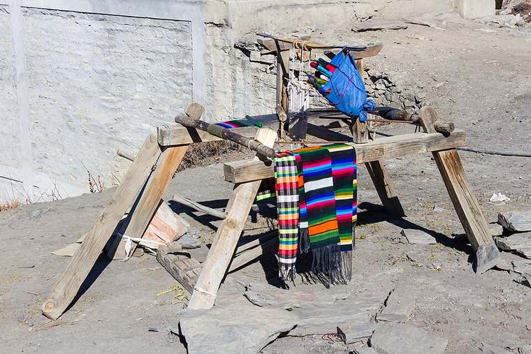 Traditional wooden handloom in Mustang, Nepal with a colorful handwoven textile